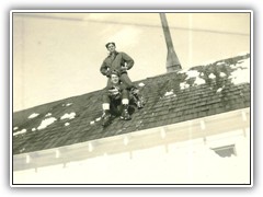 Cleaning off the barracks roof-you can just see teh corner of the window to their right